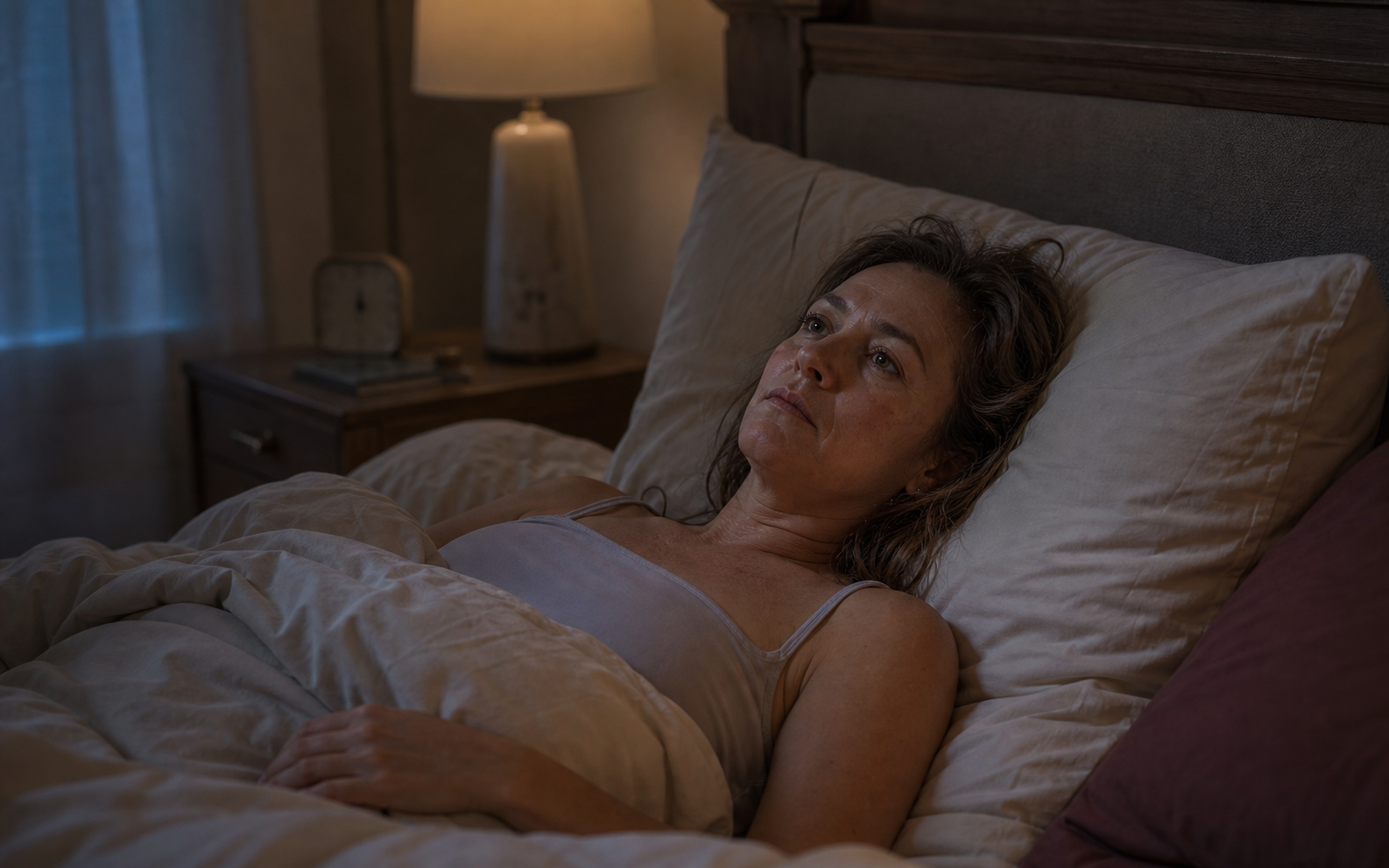 Woman lying awake in bed during the night